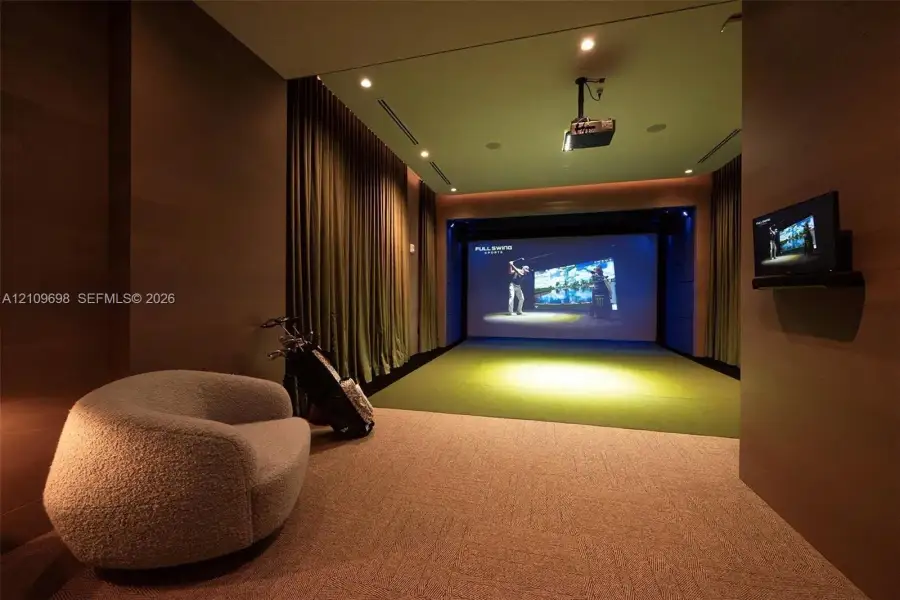 Media room featuring a built-in projector system, large projection screen, wall-to-wall carpeting, recessed ceiling lighting, and floor-to-ceiling drapery