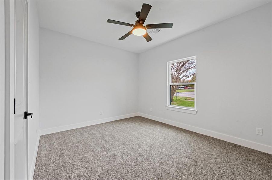 Empty room with ceiling fan and carpet