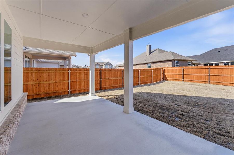 Fenced backyard with a patio