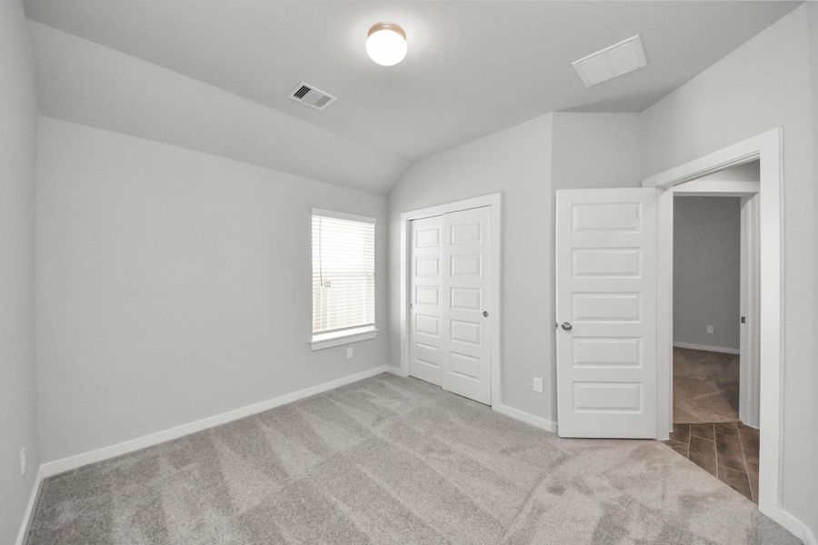 Secondary bedroom features plush carpeting, large windows that let in plenty of natural light, bright paint, and spacious closets. Secondary bedroom features plush carpeting, large windows that let in plenty of natural light, bright paint, and spacious closets.