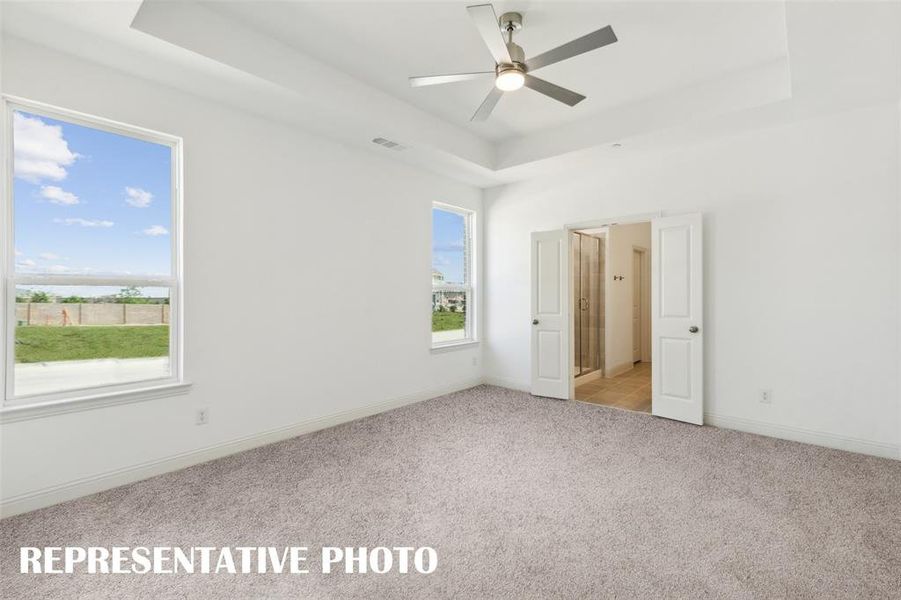 This dreamy owner's suite offers high ceilings, large windows and a grand double door entrance into the perfect owner's bath!  REPRESENTATIVE PHOTO