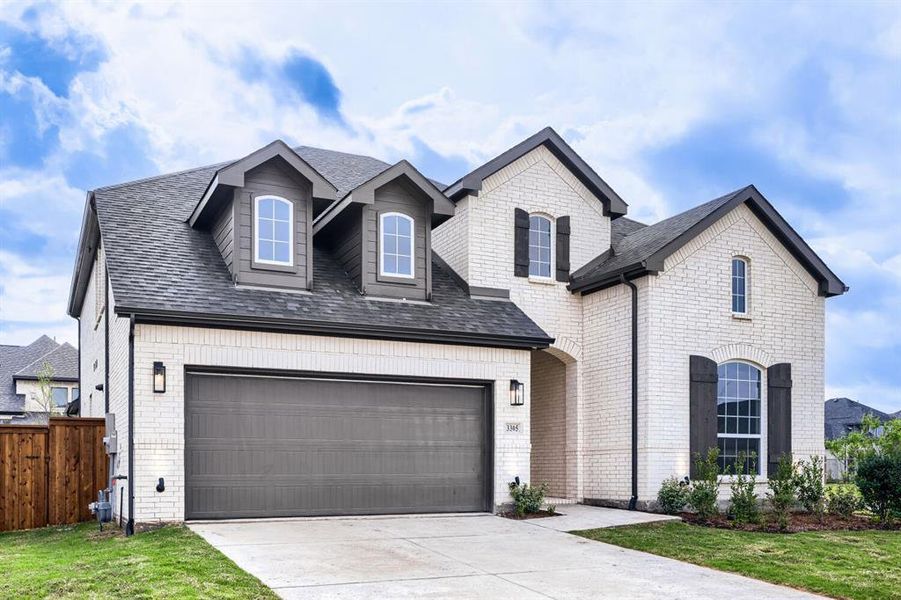 View of front facade featuring roof with shingles, concrete driveway, brick siding, and an attached garage