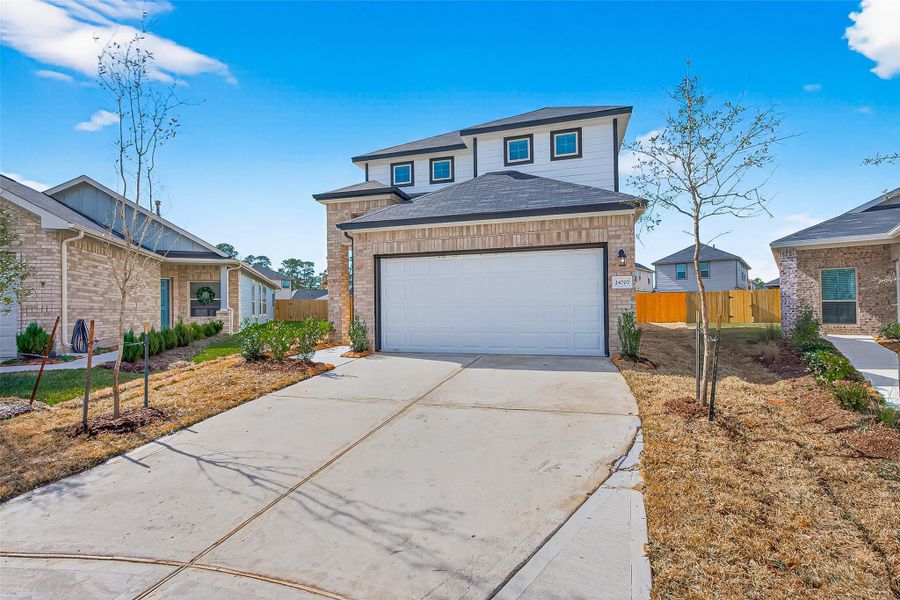 Front exterior of a new home in Woodland Lakes, Houston, TX, highlighting curb appeal (Image 22).