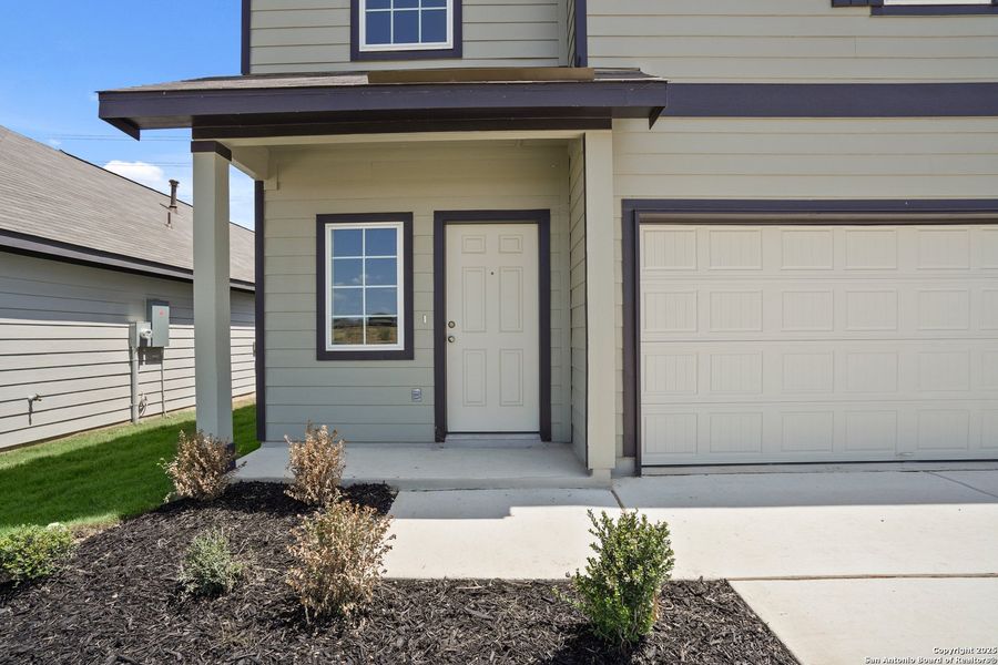 Front exterior of a new home in Hickory Ridge, Elmendorf, TX, highlighting curb appeal (Image 2). Front exterior of a new home in Hickory Ridge, Elmendorf, TX, highlighting curb appeal (Image 2).