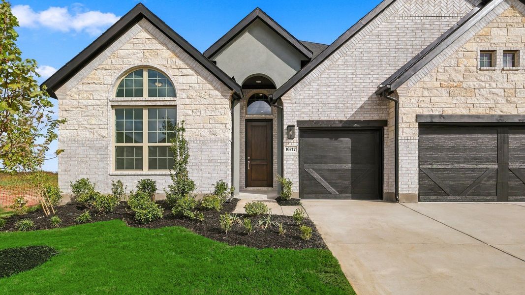 Front exterior of a new home in Green Meadows Classic, Celina, TX, highlighting curb appeal (Image 23).