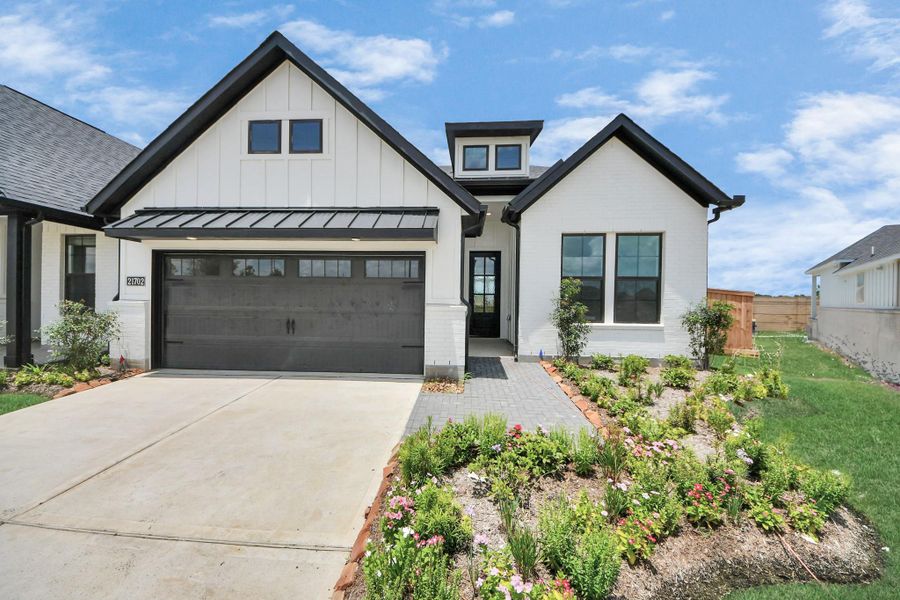 Front exterior of a new home in Bridgeland: Signature Collection, Cypress, TX, highlighting curb appeal (Image 23). Front exterior of a new home in Bridgeland: Signature Collection, Cypress, TX, highlighting curb appeal (Image 23).