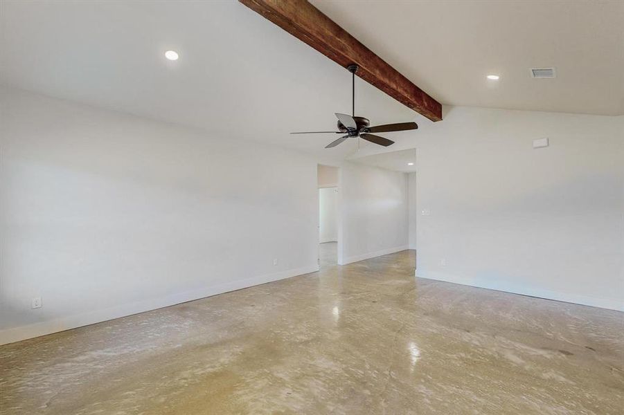 Spare room with vaulted ceiling with beams and ceiling fan