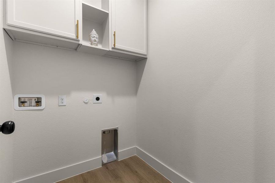 Laundry area with dark hardwood / wood-style flooring, washer hookup, cabinets, and hookup for an electric dryer