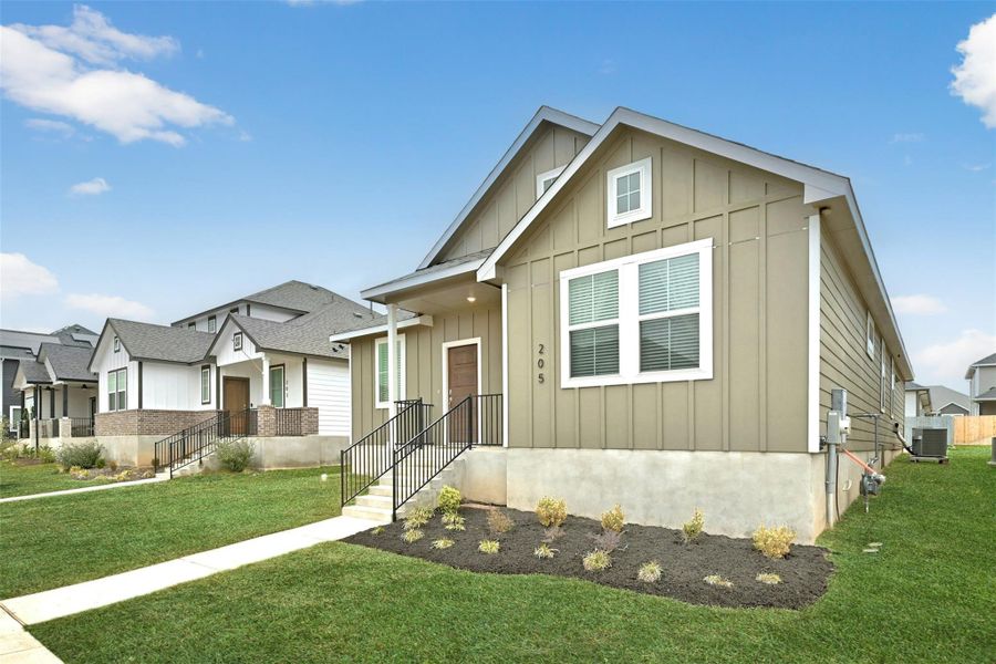 View of front of home with board and batten siding, a front lawn, and a residential view View of front of home with board and batten siding, a front lawn, and a residential view