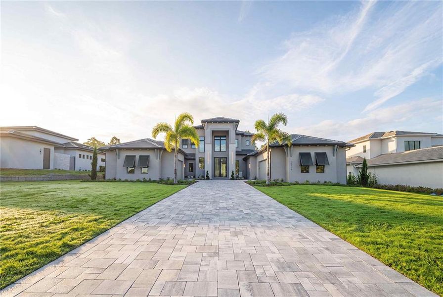 Front exterior of a new home in , Montverde, FL, highlighting curb appeal (Image 31). Front exterior of a new home in , Montverde, FL, highlighting curb appeal (Image 31).