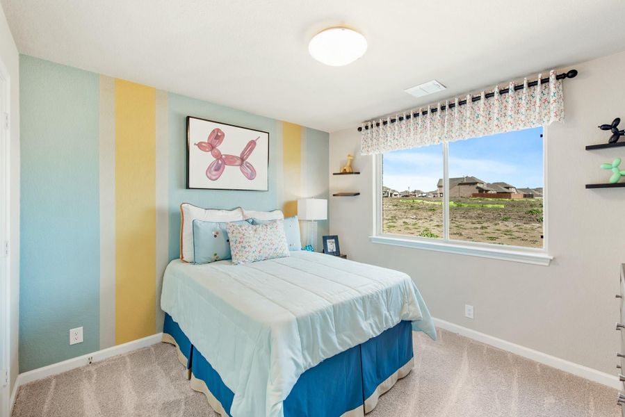 Children's bedroom with colorful striped accent wall, full bed with blue bedding, and single window with valance curtains Children's bedroom with colorful striped accent wall, full bed with blue bedding, and single window with valance curtains