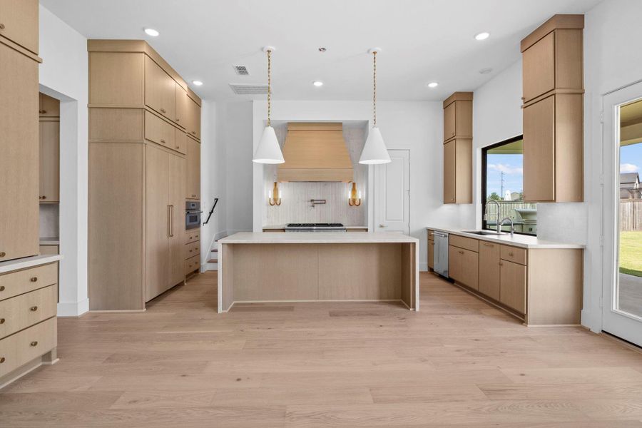 Gourmet kitchen featuring a large center island, custom cabinetry, and sophisticated finishes.