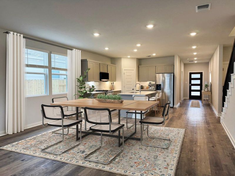 An open floorplan seamlessly connects the dining space to the modern kitchen.