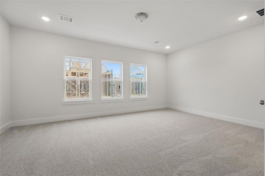 Empty room featuring light carpet and recessed lighting