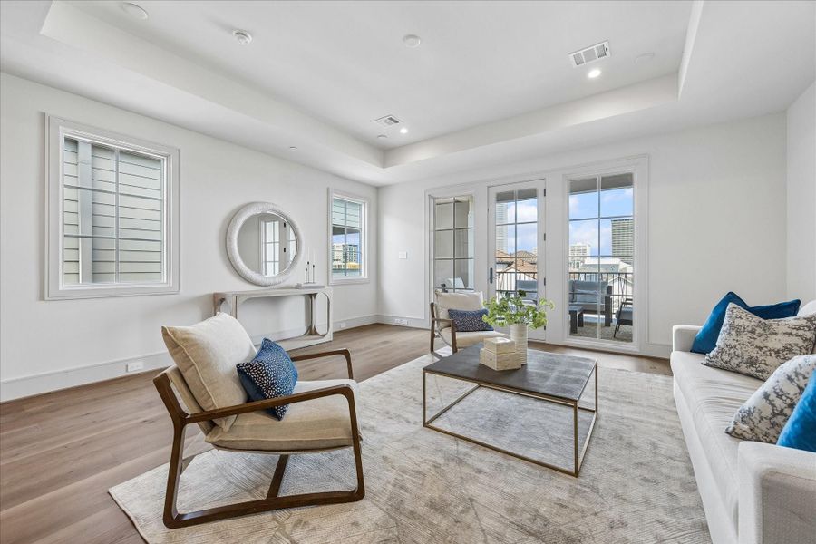 Looking out from the wet bar shows the City Room opening onto the fourth floor covered terrace.