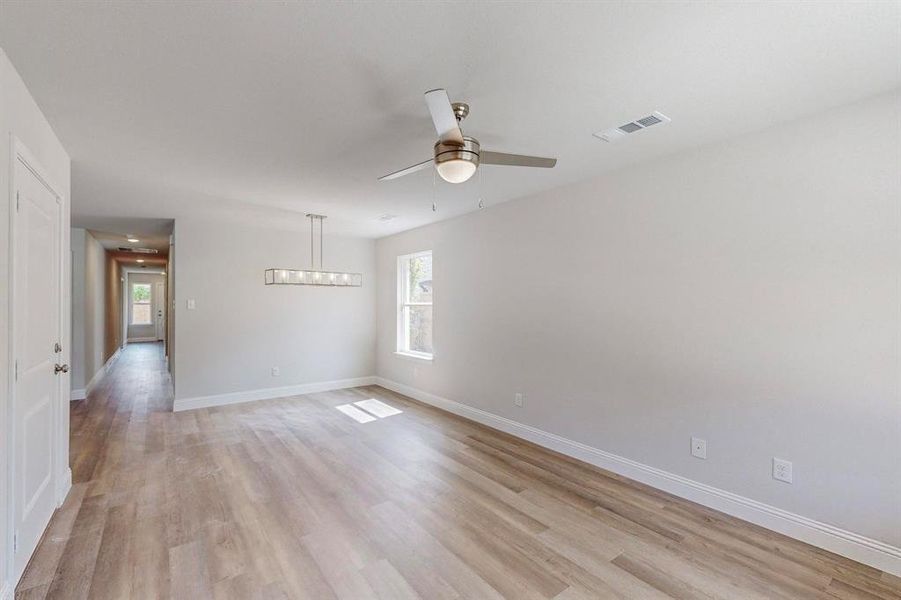 Spare room featuring ceiling fan and light hardwood / wood-style floors