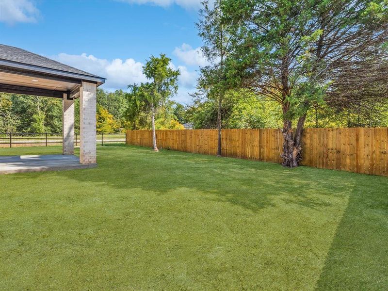Fenced backyard featuring a patio