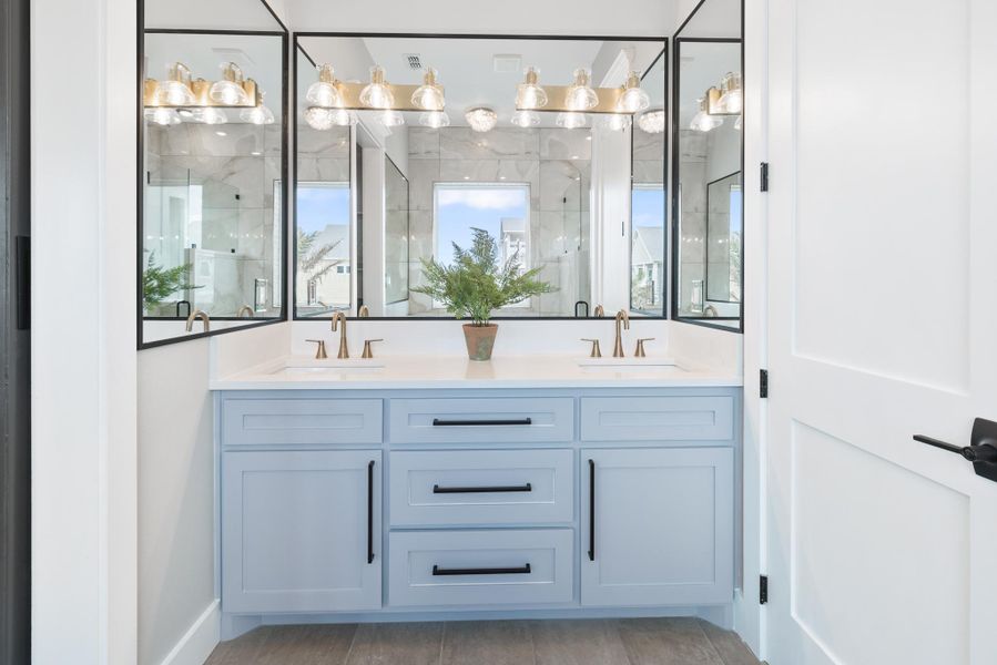 Full bath with a marble finish shower and double vanity Full bath with a marble finish shower and double vanity