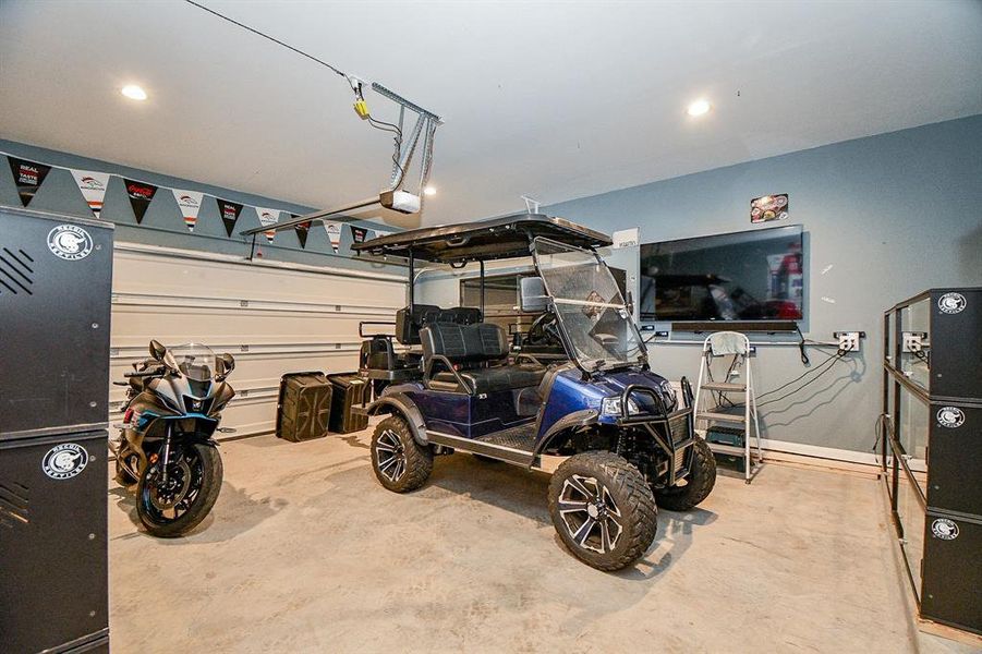 The garage is party-ready with designer paint, recessed lighting, and plenty of space for your projects, hobbies, or extra storage needs.