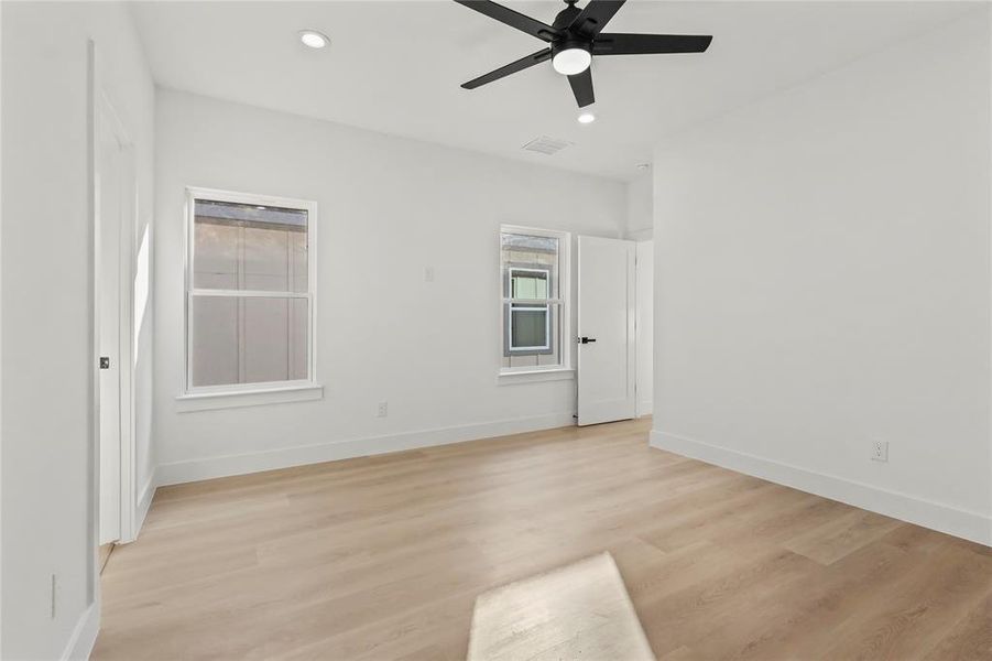 Spare room with recessed lighting, light wood finished floors, and ceiling fan Spare room with recessed lighting, light wood finished floors, and ceiling fan