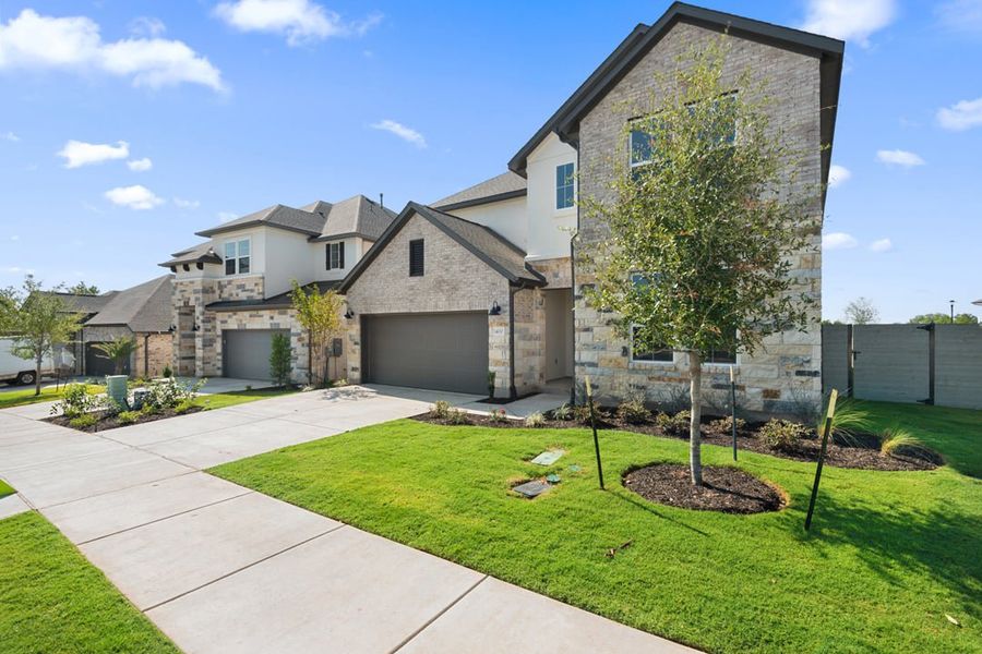 Front exterior of a new home in Park Collection At Wolf Ranch, Georgetown, TX, highlighting curb appeal (Image 28).