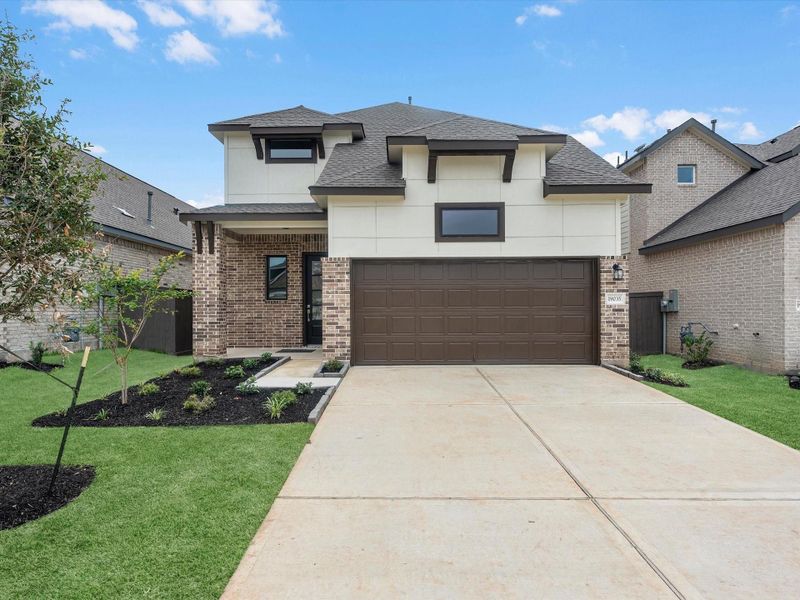 Front exterior of a new home in Emory Glen, Magnolia, TX, highlighting curb appeal (Image 2). Front exterior of a new home in Emory Glen, Magnolia, TX, highlighting curb appeal (Image 2).