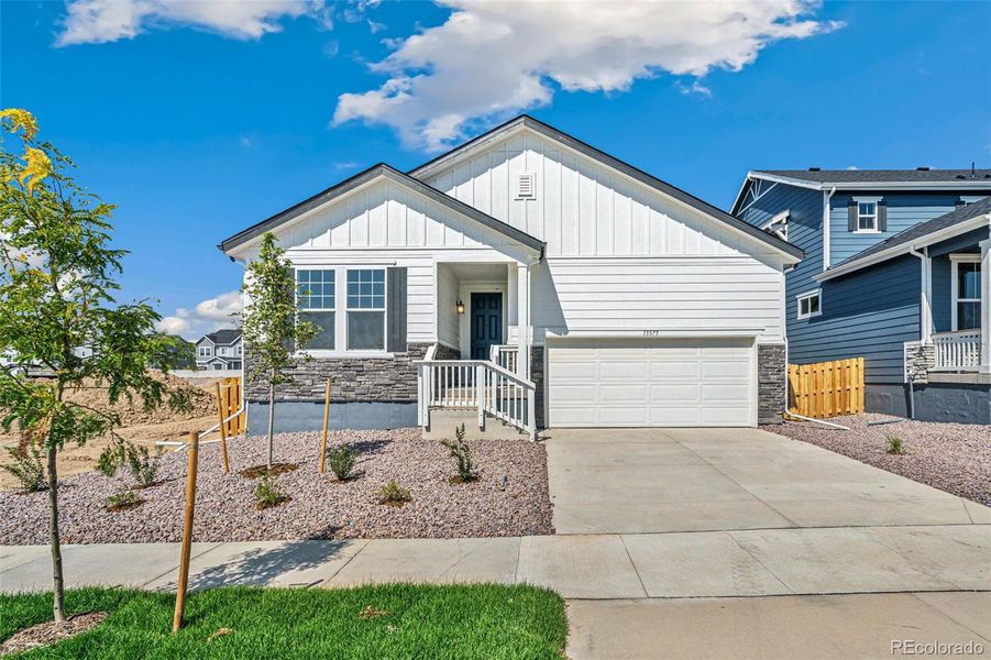 Front exterior of a new home in Turnberry, Commerce City, CO, highlighting curb appeal (Image 19).