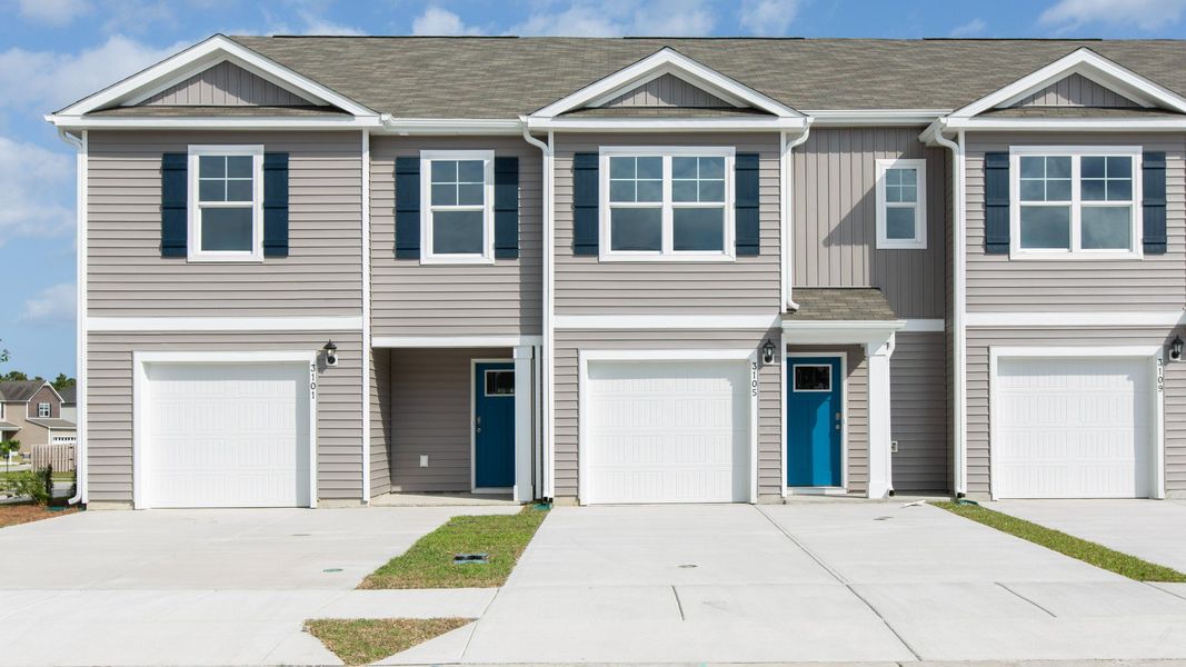 Front exterior of a new home in The Landing at Sidbury Station, Castle Hayne, NC, highlighting curb appeal (Image 1). Front exterior of a new home in The Landing at Sidbury Station, Castle Hayne, NC, highlighting curb appeal (Image 1).