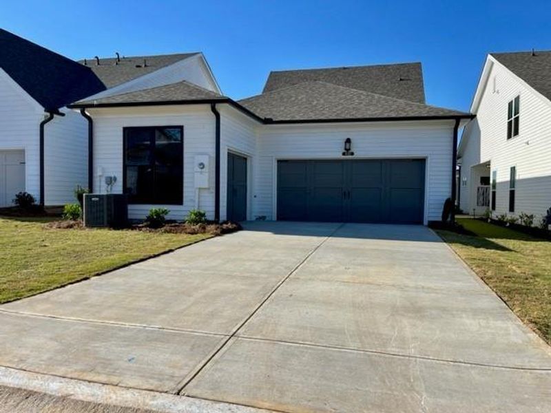 Front exterior of a new home in Promenade at Sawnee Village, Cumming, GA, highlighting curb appeal (Image 28).