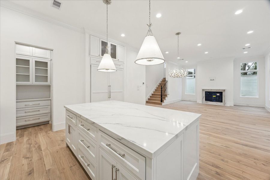 Completing the kitchen is the pantry with built-in storage and large island with no sink, to allow for maximum prep space.