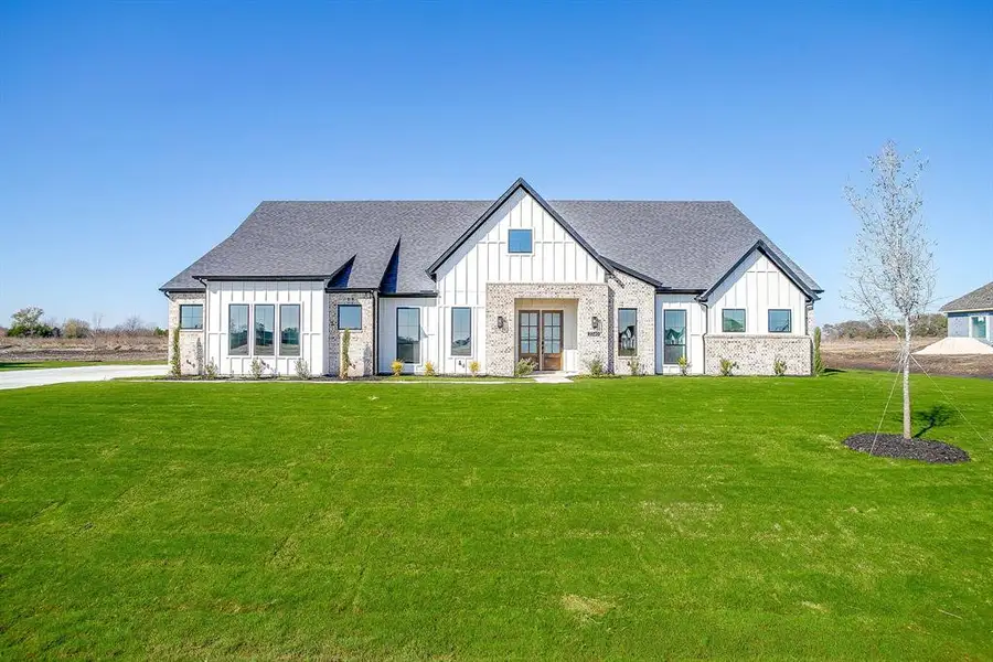 Front exterior of a new home in Waterfall Ranch, Waxahachie, TX, highlighting curb appeal (Image 1).