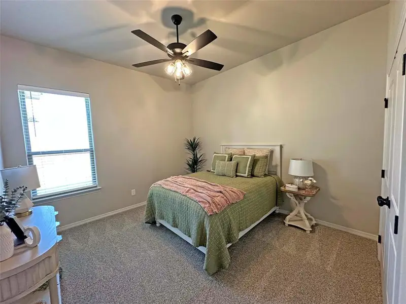 Bedroom with carpet floors and ceiling fan Bedroom with carpet floors and ceiling fan