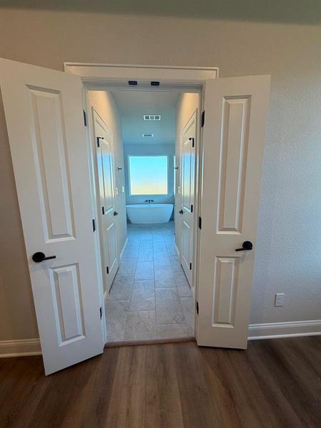 Corridor featuring wood finished floors and baseboards