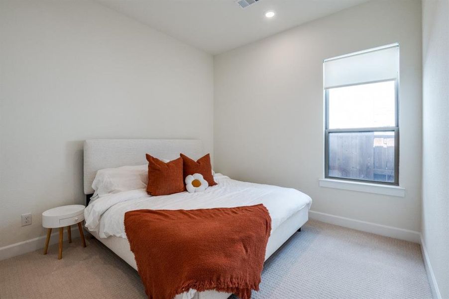 Carpeted bedroom with baseboards and recessed lighting Carpeted bedroom with baseboards and recessed lighting