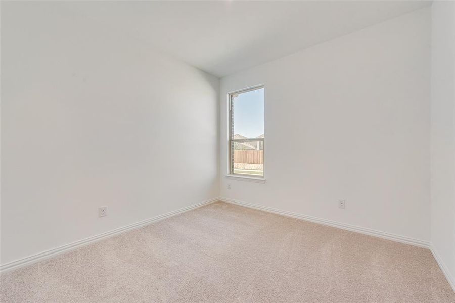 Spare room featuring light colored carpet