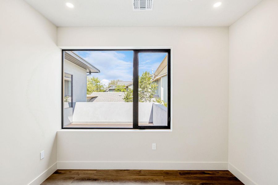 Empty room featuring wood finished floors and recessed lighting