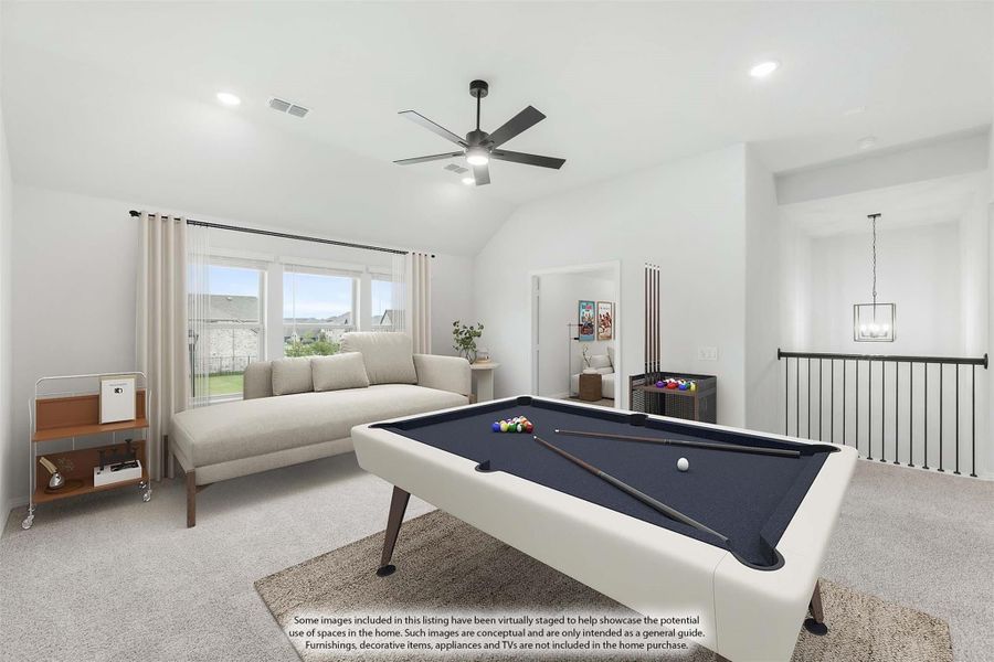 Upstairs game room with pool table, vaulted ceiling, ceiling fan, and carpet flooring near staircase railing Upstairs game room with pool table, vaulted ceiling, ceiling fan, and carpet flooring near staircase railing