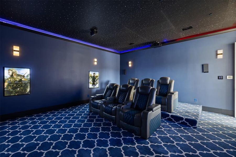 Carpeted cinema room with ornamental molding