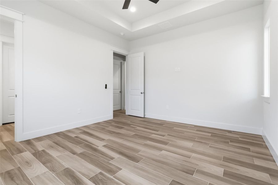 Primary bedroom with view of door to ensuite