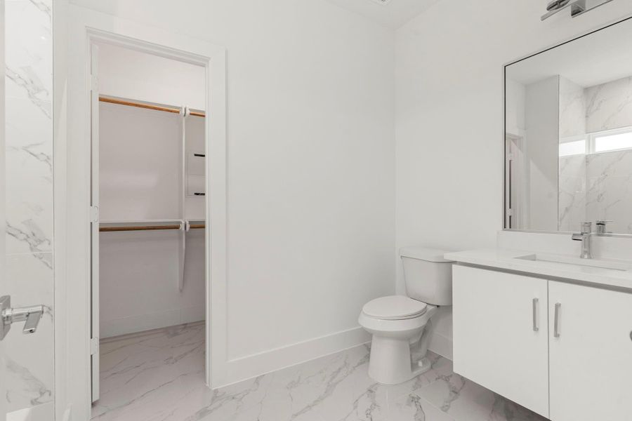Secondary bathroom features a shower/tub combo.
