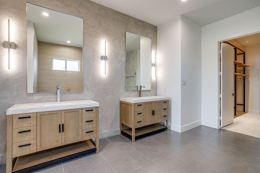 Full bathroom featuring recessed lighting, two vanities, and light tile patterned floors Full bathroom featuring recessed lighting, two vanities, and light tile patterned floors