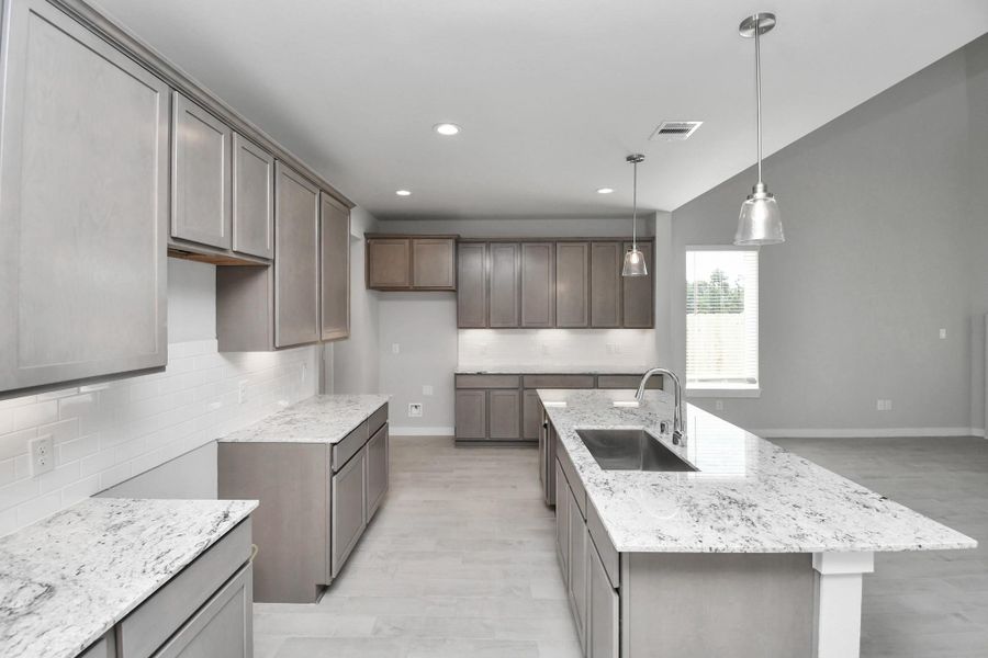 This kitchen is by far any chef’s dream! This spacious kitchen features high ceilings, stained wood cabinets, granite countertop, SS appliances, modern tile backsplash, recessed lighting, extended counter space, granite kitchen island with double sink, and space for breakfast bar, and a walk-in pantry all overlooking your huge family room. Sample photo of completed home with similar floor plan. Actual colors and selections may vary. This kitchen is by far any chef’s dream! This spacious kitchen features high ceilings, stained wood cabinets, granite countertop, SS appliances, modern tile backsplash, recessed lighting, extended counter space, granite kitchen island with double sink, and space for breakfast bar, and a walk-in pantry all overlooking your huge family room. Sample photo of completed home with similar floor plan. Actual colors and selections may vary.