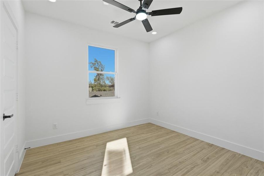 Spare room with light wood-style floors, a ceiling fan, and recessed lighting Spare room with light wood-style floors, a ceiling fan, and recessed lighting