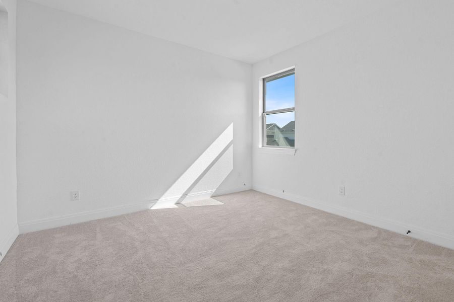 Carpeted empty room featuring baseboards Carpeted empty room featuring baseboards