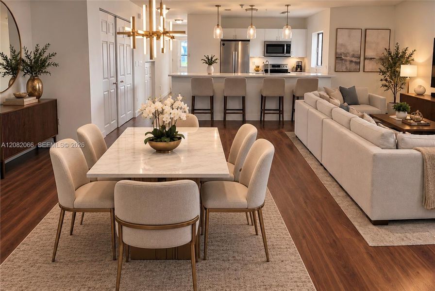 AI Generated Open concept space featuring wood-finish flooring, recessed lighting, a modern multi-arm chandelier, and a kitchen equipped with white cabinetry, stainless steel appliances, and a breakfast bar