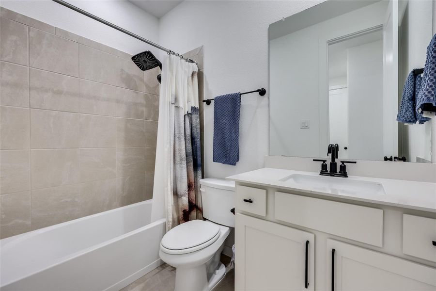 Clean lines and stone counters highlight this modern bathroom with its tiled shower and tub. Clean lines and stone counters highlight this modern bathroom with its tiled shower and tub.
