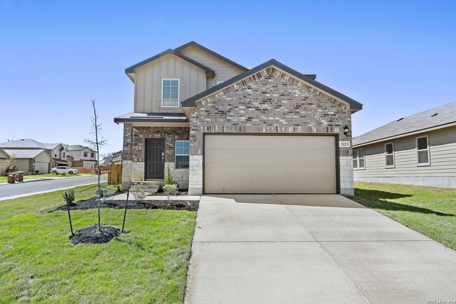Front exterior of a new home in Laurel Vistas, San Antonio, TX, highlighting curb appeal (Image 2). Front exterior of a new home in Laurel Vistas, San Antonio, TX, highlighting curb appeal (Image 2).