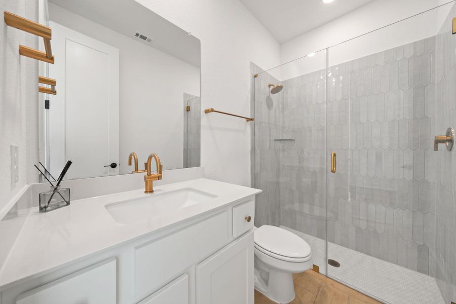 Full bath featuring vanity, a stall shower, and wood finished floors