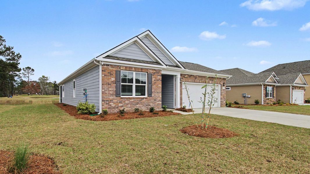 Front exterior of a new home in The Bluffs at Mill Creek, Florence, SC, highlighting curb appeal (Image 17). Front exterior of a new home in The Bluffs at Mill Creek, Florence, SC, highlighting curb appeal (Image 17).