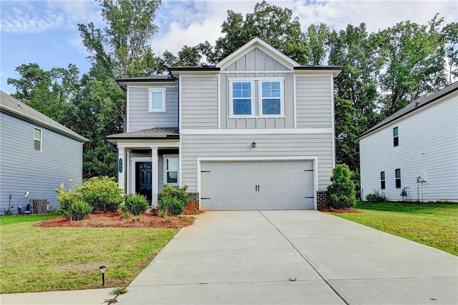 Front exterior of a new home in , Braselton, GA, highlighting curb appeal (Image 24).